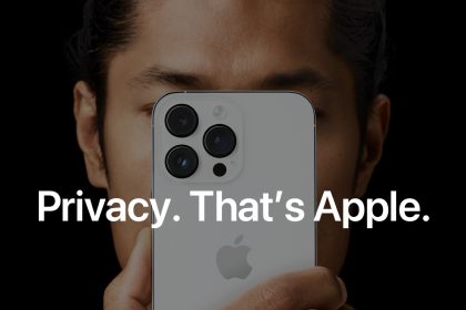 Person holding a white iPhone with triple camera setup close to their face, with the text “Privacy. That’s Apple.” prominently displayed, highlighting Apple’s emphasis on user privacy