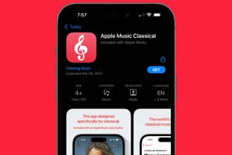 Apple Music Classical app listing on an iPhone screen, highlighting the ‘Coming Soon’ status with an expected release date of March 28, 2023, against a bright red background