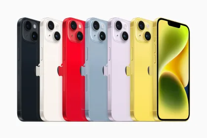 Lineup of Apple iPhone 14 models in various colors including black, white, red, blue, purple, and yellow, displayed against a white background