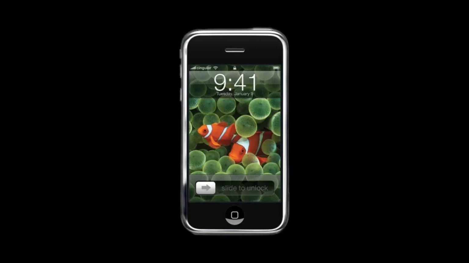 Image of the original iPhone with a black background, featuring the classic ‘slide to unlock’ screen with a clownfish wallpaper