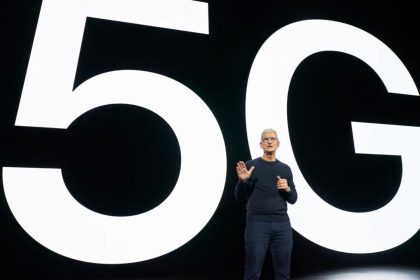 Apple CEO Tim Cook presenting in front of a large ‘5G’ backdrop, emphasizing the company’s commitment to 5G technology