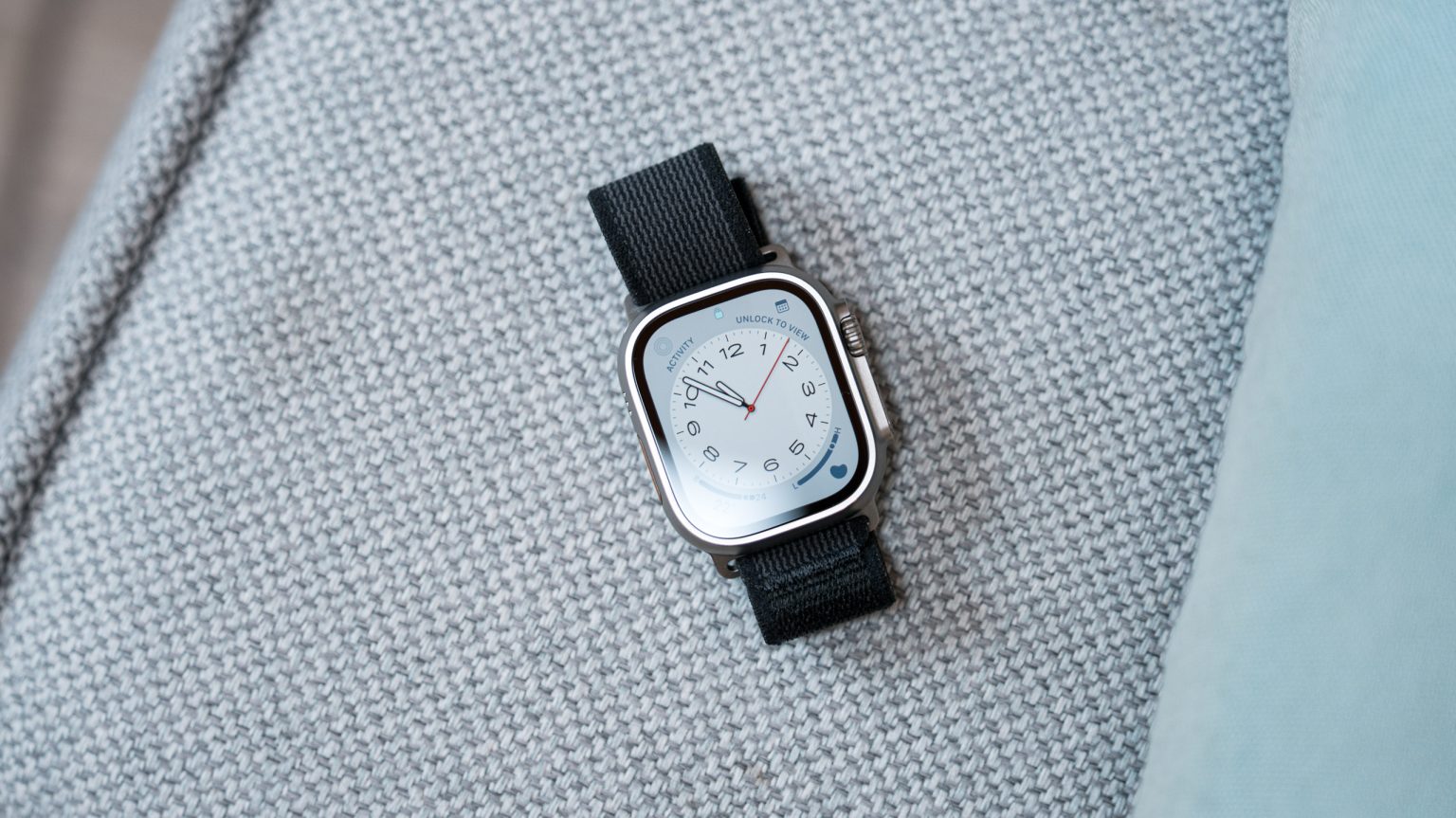 Apple Watch Ultra with a white face.